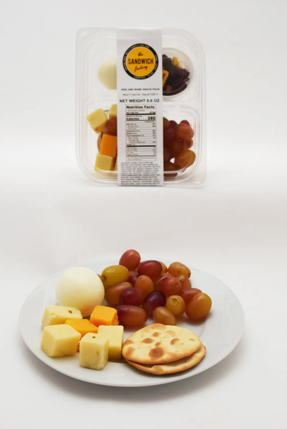 Crackers, grapes and cheese on a small plate
